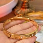 Double C 3D engraved gold-plated open bracelet, front view