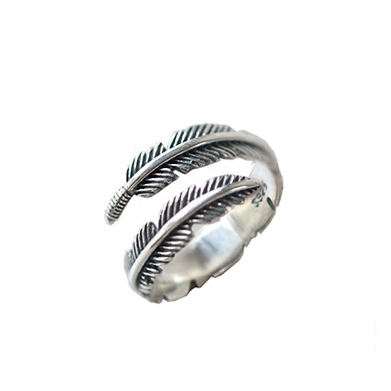 Close-up of elegant feather open silver ring design