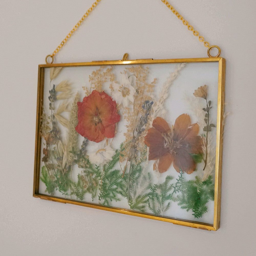 Close-up of eternal pressed bouquet in metal frame landscape design