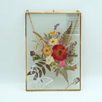 Close-up of eternal pressed bouquet in metal frame portrait design