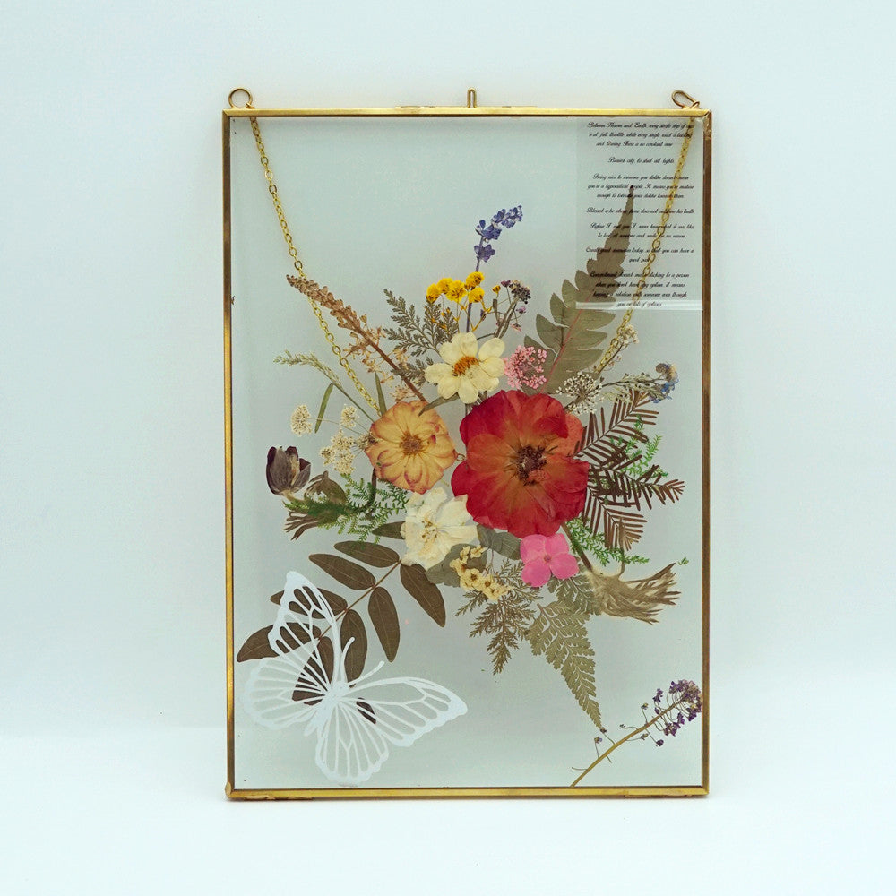 Close-up of eternal pressed bouquet in metal frame portrait design