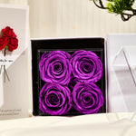 Bloom and Forever Eternal Rose Jewelry Drawer Gift Box with white outer gift box lid open, revealing the black leatherette drawer box topped with four purple preserved roses, displayed on a cream surface with an Especially for You greeting card beside it