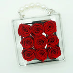 Close-up of petite eternal red rose in acrylic handbag gift box