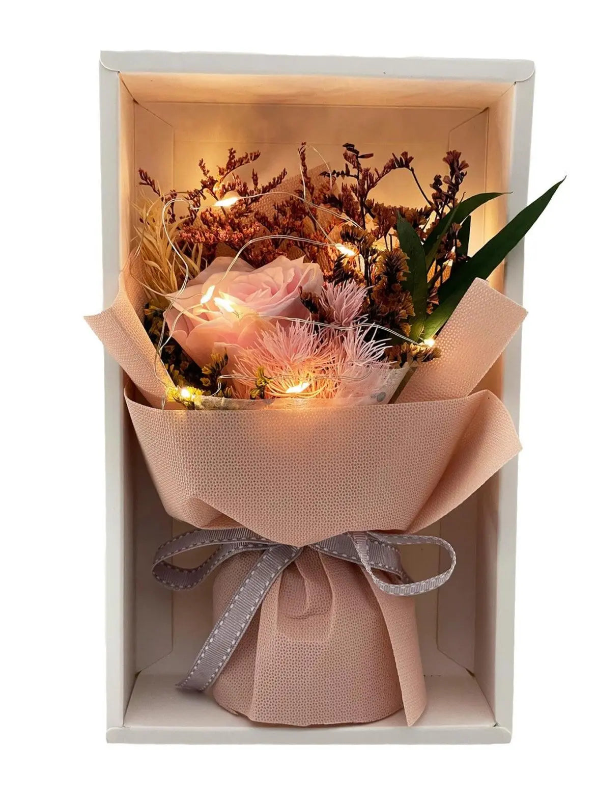 Close-up of petite eternal pink rose bouquet – Fairy Light Edition