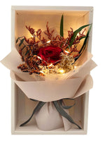 Close-up of petite eternal red rose bouquet – Fairy Light Edition