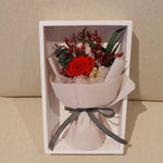 Close-up of petite eternal red rose bouquet – Fairy Light Edition