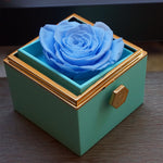 Close-up of blue rotating eternal rose and jewelry gift box details