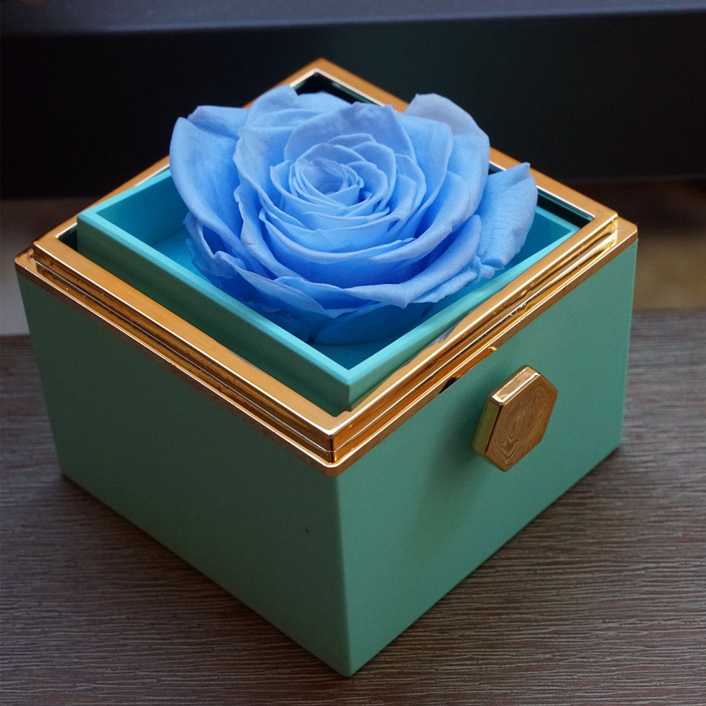 Close-up of blue rotating eternal rose and jewelry gift box details