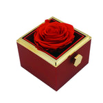 Close-up of red rotating eternal rose and jewelry gift box details