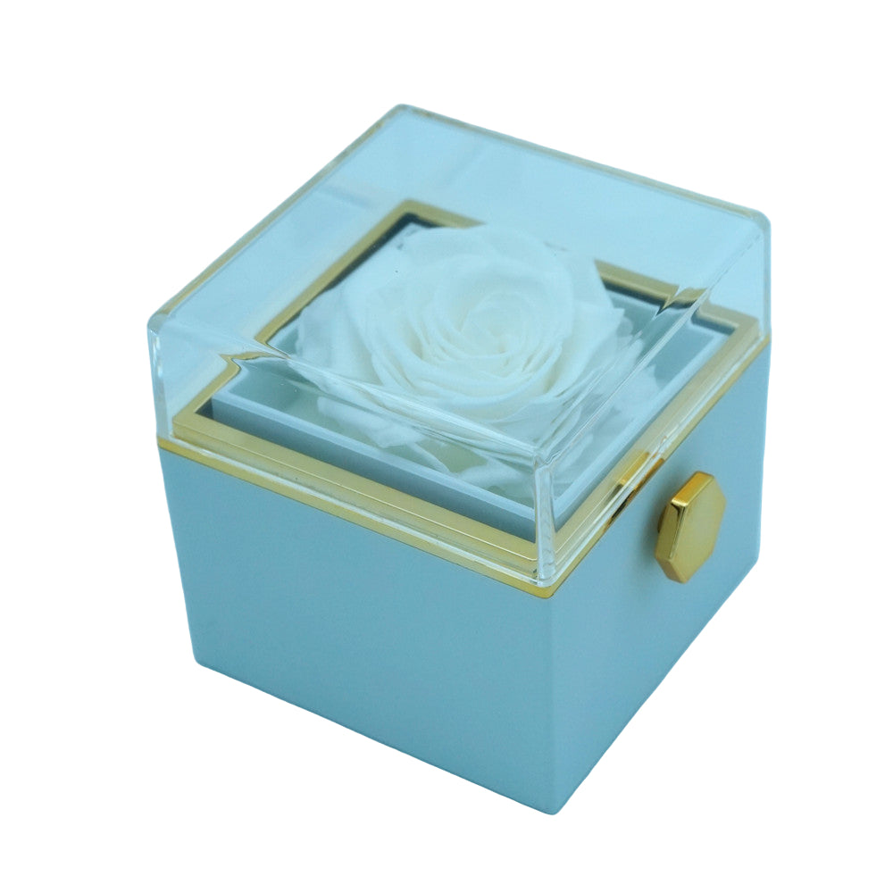 Close-up of white rotating eternal rose and jewelry gift box details
