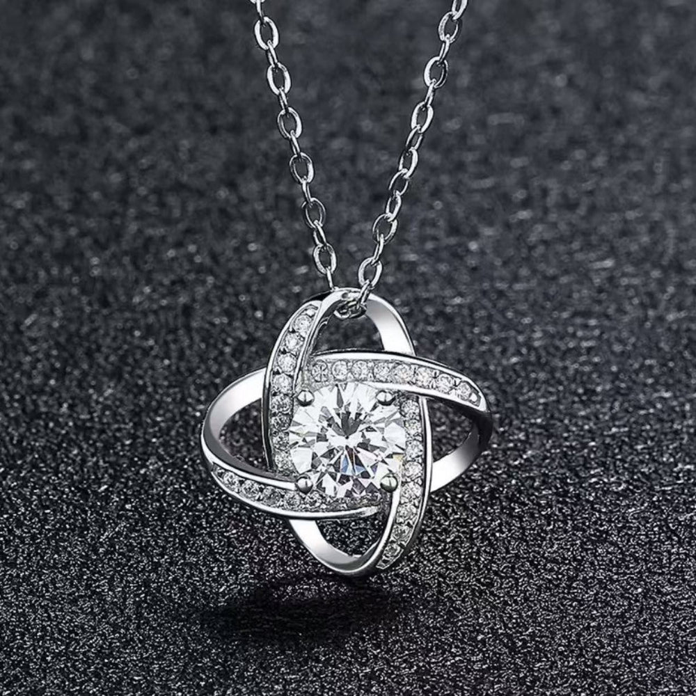 Close-up of trendy openwork four-leaf clover necklace design